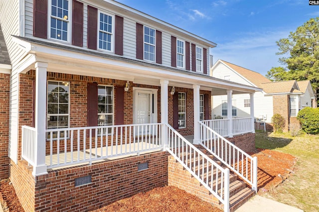 view of front of house with brick siding and a porch