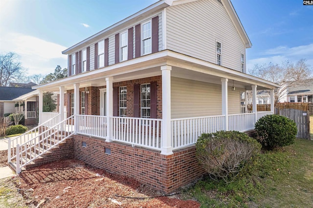 view of front of house with brick siding and covered porch