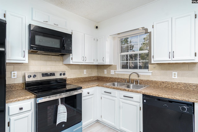 kitchen with a sink, decorative backsplash, black appliances, a textured ceiling, and white cabinetry