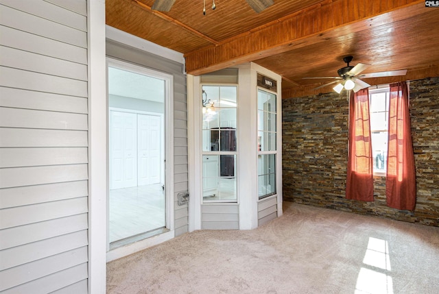 unfurnished sunroom with wooden ceiling and a ceiling fan