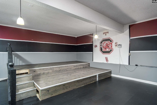 miscellaneous room with baseboards and a textured ceiling