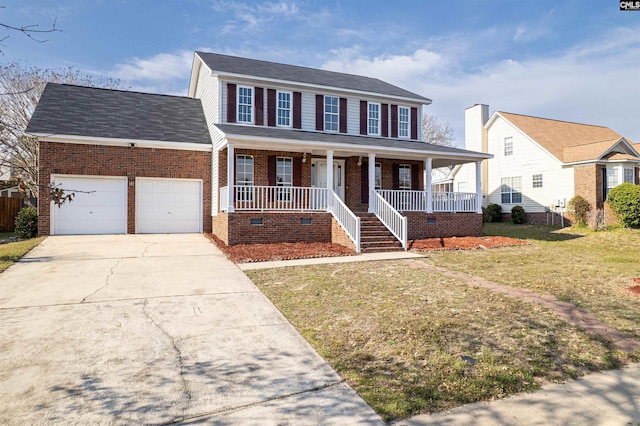 colonial house with a porch, concrete driveway, a front yard, an attached garage, and brick siding