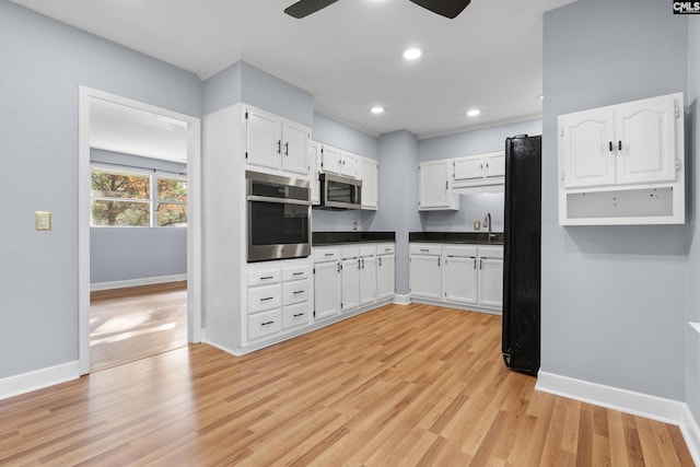 kitchen featuring appliances with stainless steel finishes, white cabinetry, and a ceiling fan