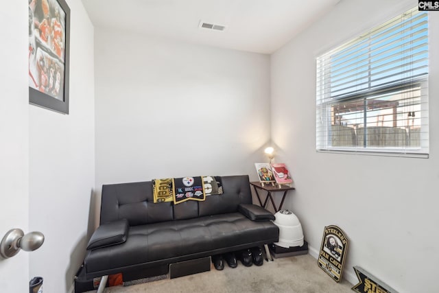 sitting room featuring carpet flooring, baseboards, and visible vents