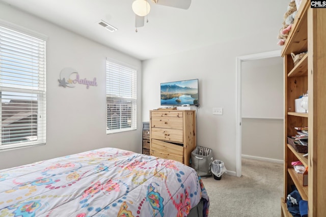 bedroom featuring ceiling fan, carpet, visible vents, and baseboards