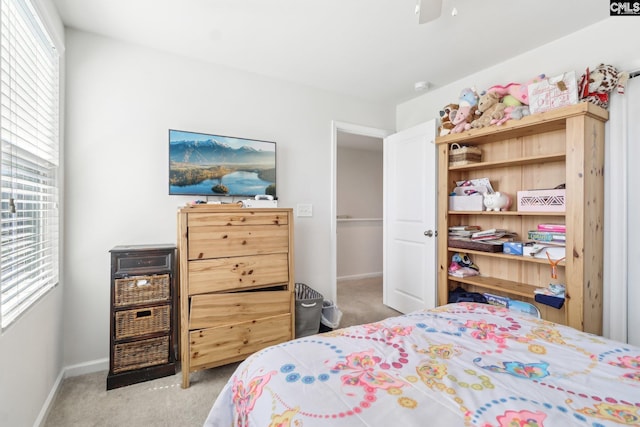 carpeted bedroom with baseboards, multiple windows, and ceiling fan