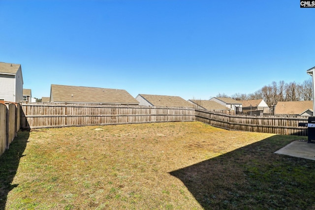 view of yard featuring a residential view and a fenced backyard