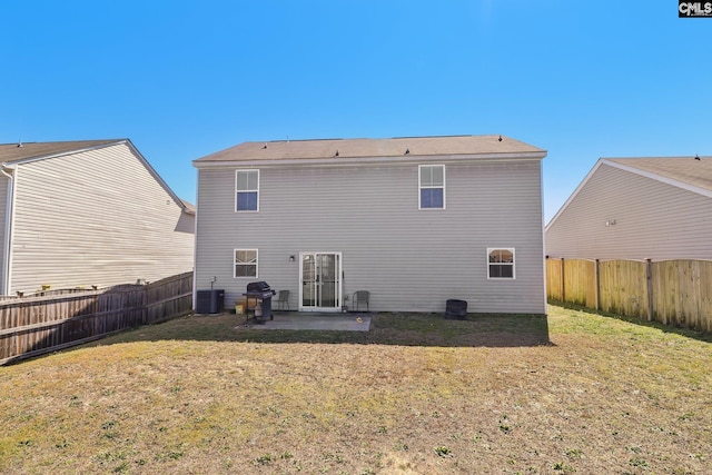 back of property with cooling unit, a patio, and a lawn