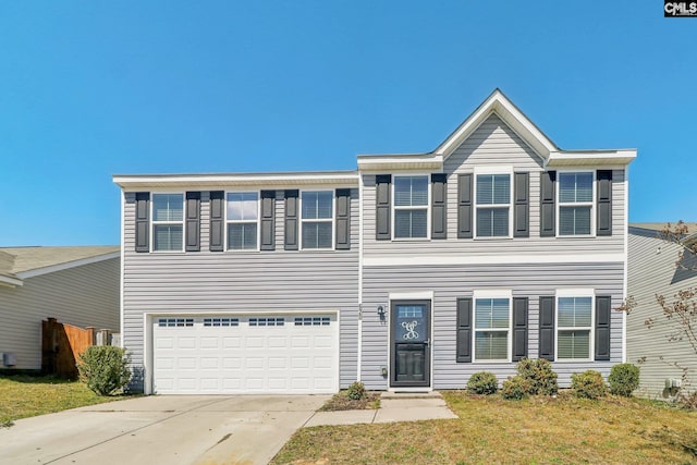 view of front of home with an attached garage, driveway, and a front yard