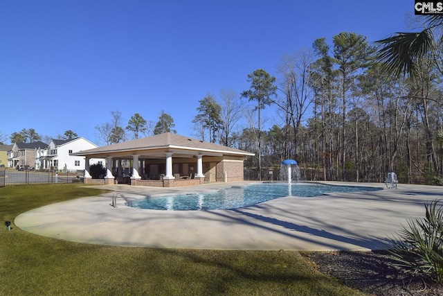 community pool featuring a patio and fence