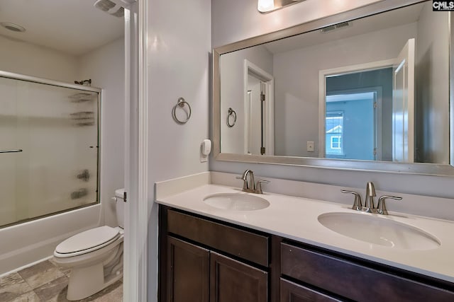 full bath with double vanity, visible vents, toilet, and a sink