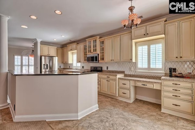 kitchen with appliances with stainless steel finishes, cream cabinets, and an inviting chandelier