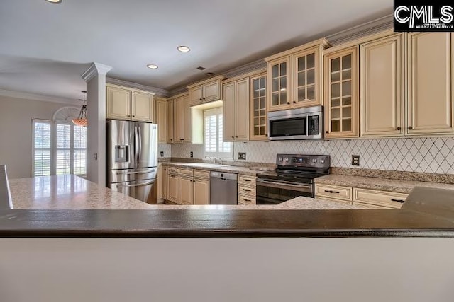 kitchen featuring backsplash, glass insert cabinets, crown molding, appliances with stainless steel finishes, and cream cabinetry