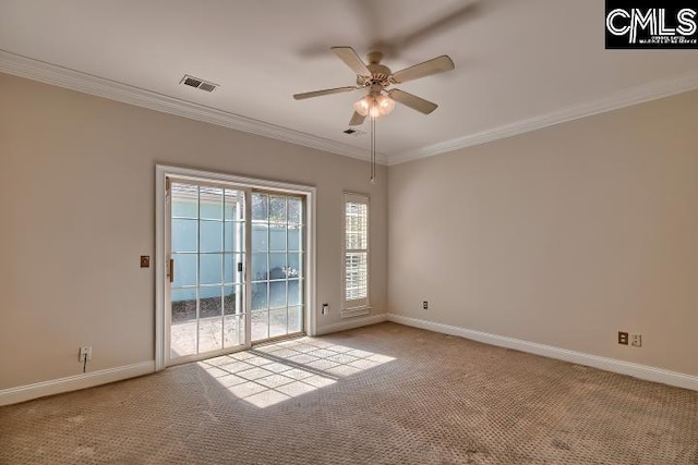 spare room with visible vents, baseboards, ornamental molding, carpet flooring, and a ceiling fan