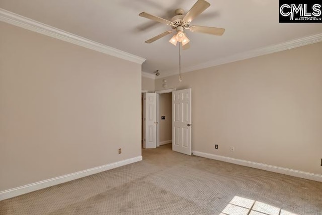 empty room with crown molding, a ceiling fan, baseboards, and light carpet