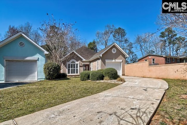 ranch-style house featuring stucco siding, driveway, fence, a front yard, and a garage