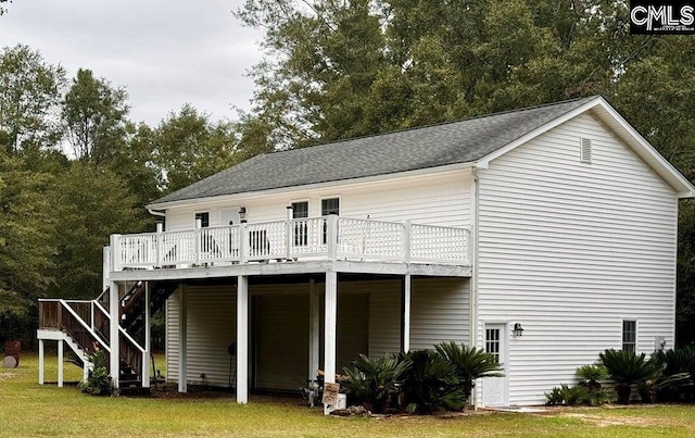 back of house featuring stairs, a lawn, a shingled roof, and a wooden deck