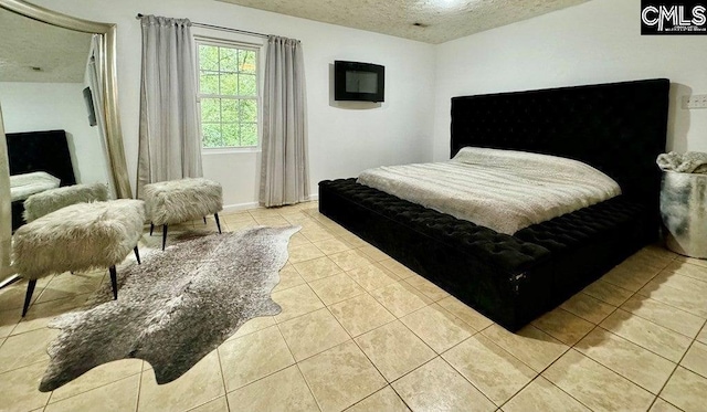 tiled bedroom featuring a textured ceiling