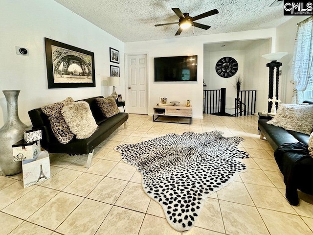 living area with tile patterned floors, a textured ceiling, and ceiling fan