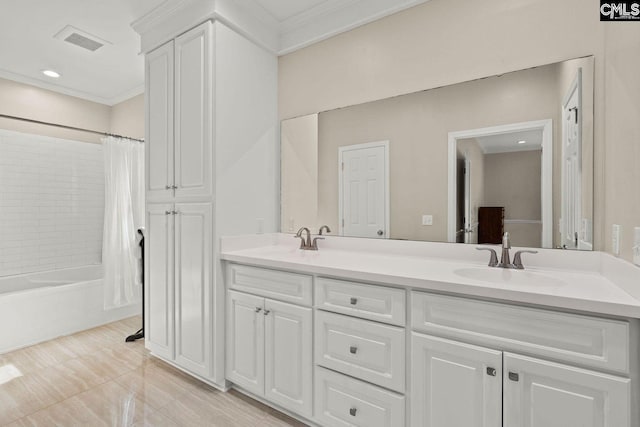 bathroom with double vanity, shower / bath combo, visible vents, and a sink