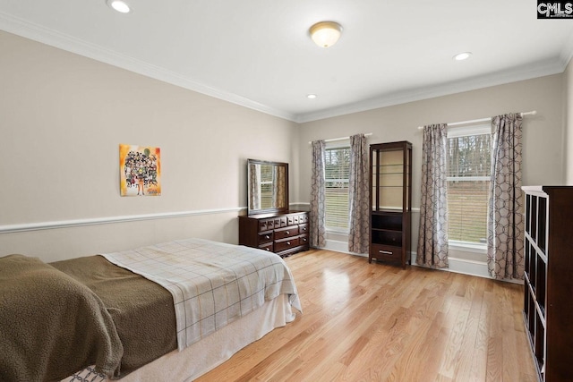 bedroom featuring recessed lighting, multiple windows, crown molding, and wood finished floors