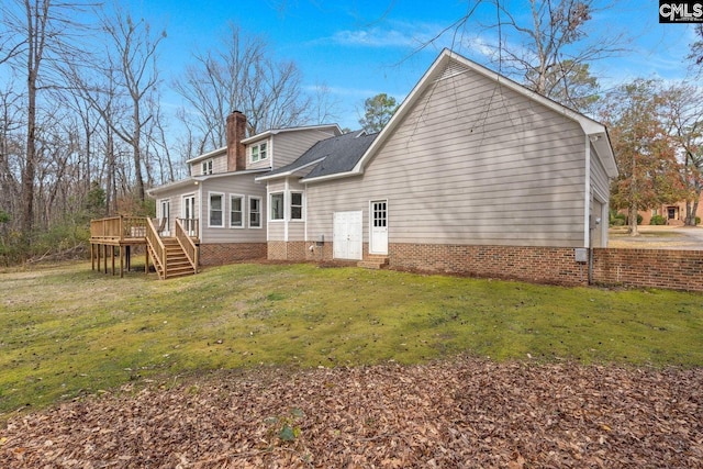 back of house with a lawn, a chimney, stairs, and a deck