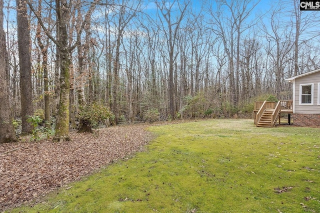 view of yard with stairs and a deck