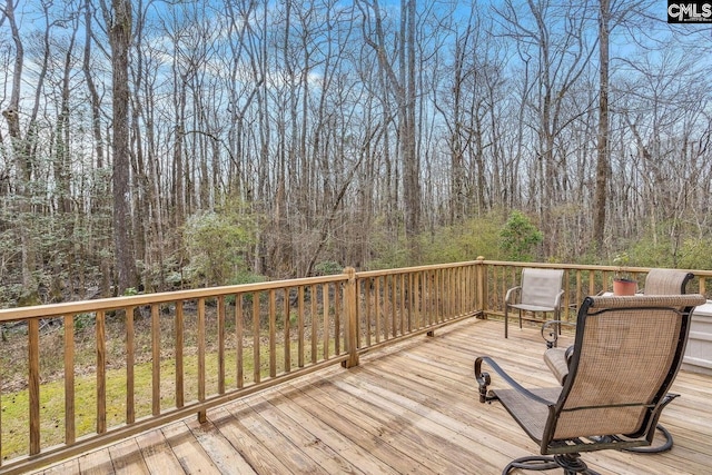 wooden deck featuring a forest view