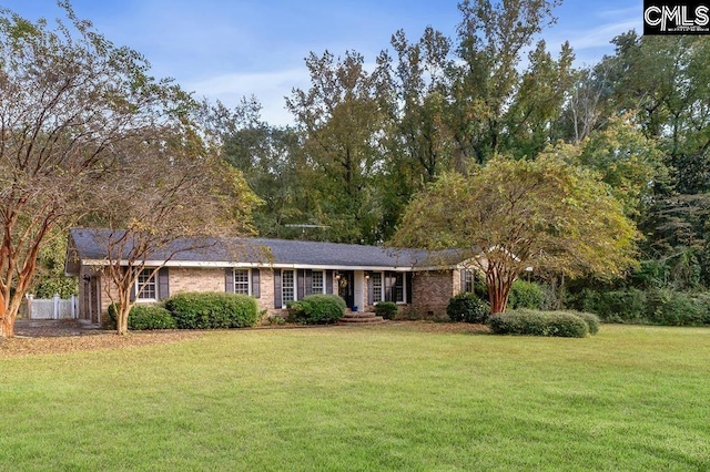 ranch-style house featuring a front lawn, fence, and brick siding