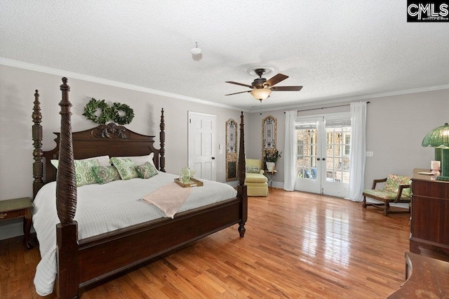 bedroom with french doors, light wood-style flooring, ornamental molding, and access to outside