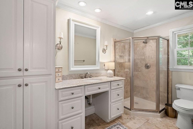 bathroom with a stall shower, toilet, crown molding, and vanity