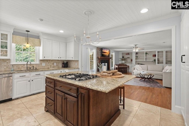 kitchen with a sink, crown molding, and stainless steel appliances