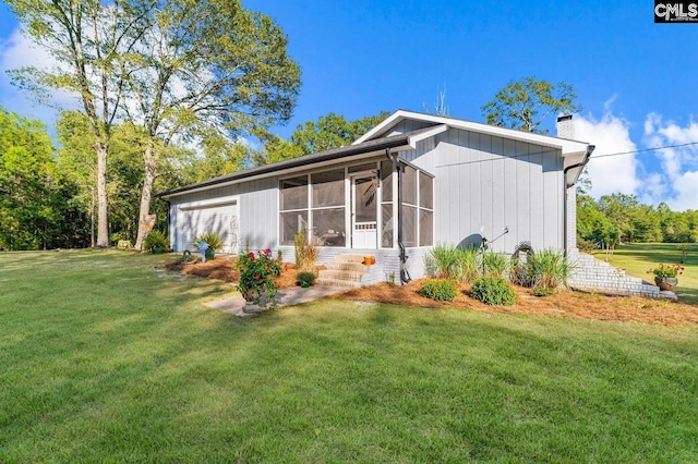 164 Carriageton Dr, Orangeburg, SC 29115 - view of property exterior with a yard, a garage, a sunroom, and a chimney