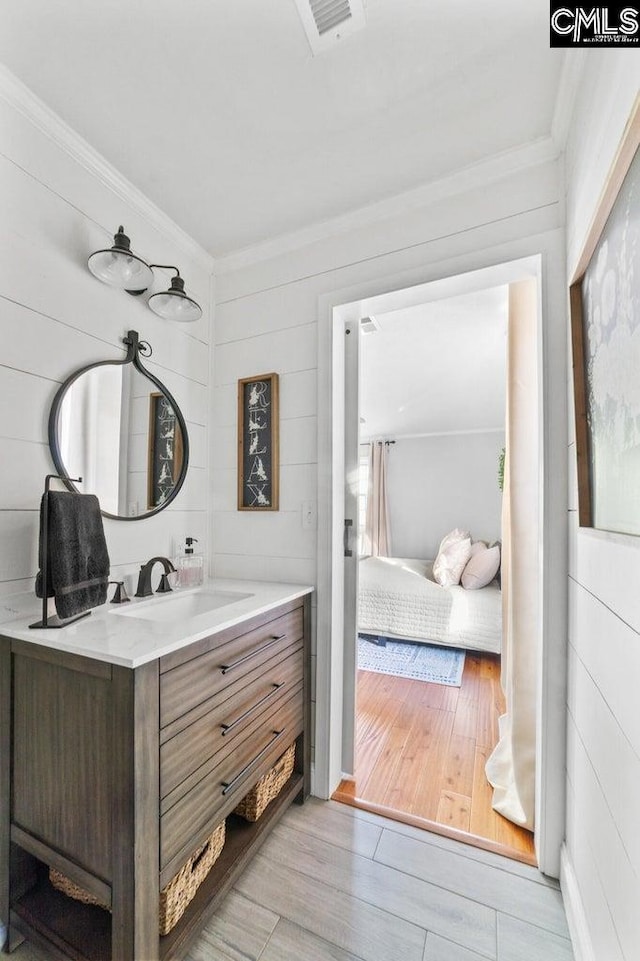 164 Carriageton Dr, Orangeburg, SC 29115 - bathroom featuring visible vents, vanity, wood finished floors, and crown molding