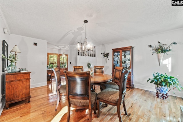 164 Carriageton Dr, Orangeburg, SC 29115 - dining space featuring a notable chandelier, a textured ceiling, light wood-style floors, crown molding, and baseboards