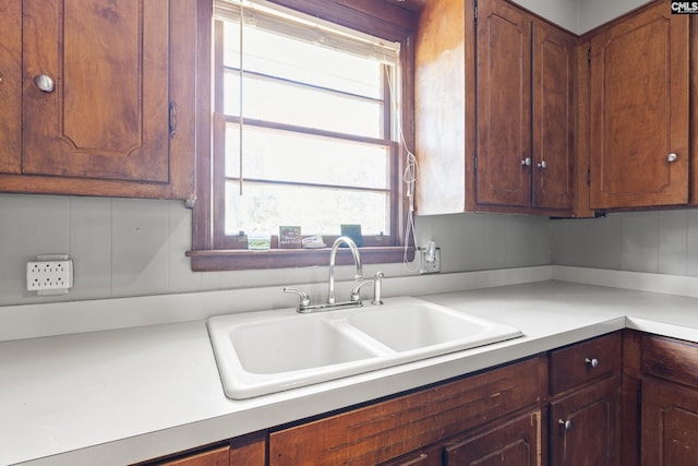 kitchen featuring a sink and light countertops