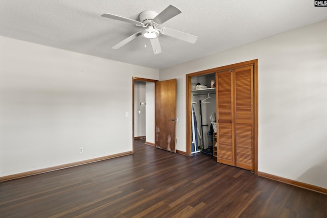 unfurnished bedroom featuring dark wood-style floors, baseboards, a closet, and a textured ceiling