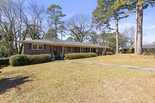 ranch-style house with a front lawn and brick siding
