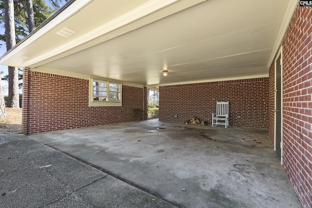 view of patio / terrace with an attached carport and driveway