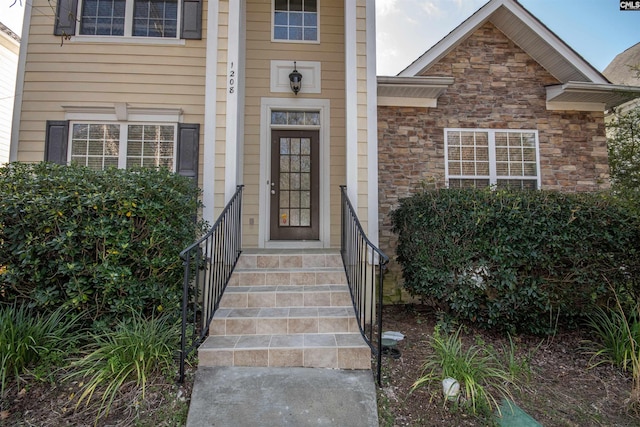 doorway to property featuring stone siding