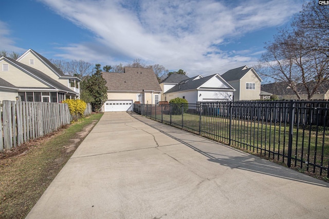 view of road featuring a residential view and driveway