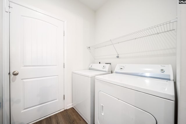 washroom with washer and dryer, dark wood finished floors, and laundry area