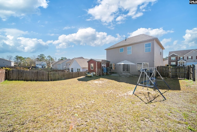 view of yard featuring a patio area, a residential view, and a fenced backyard