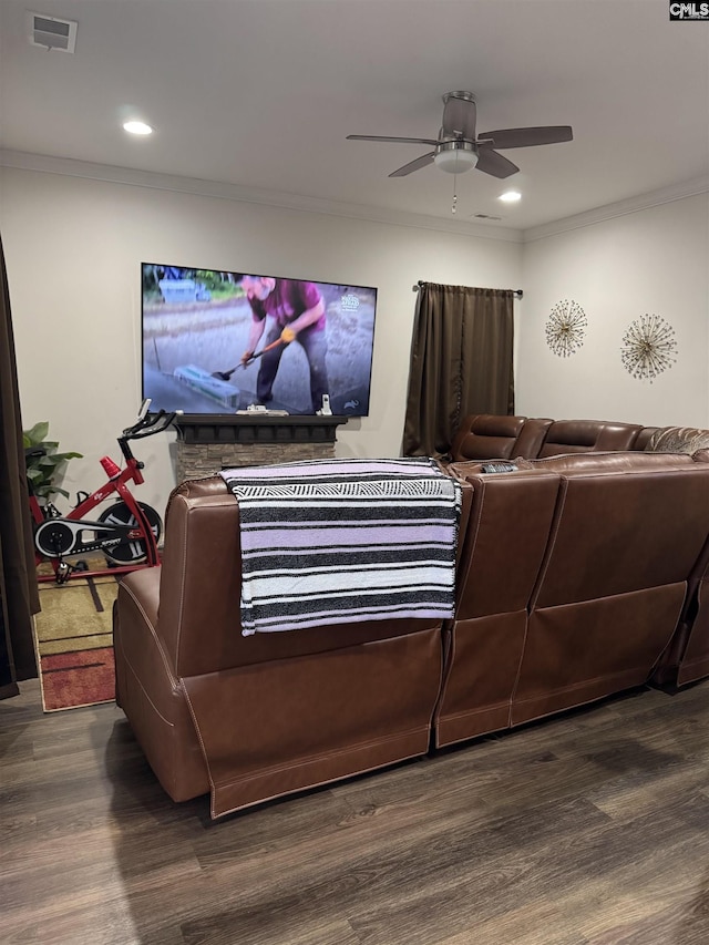 living area featuring dark wood-style floors, visible vents, crown molding, and a ceiling fan