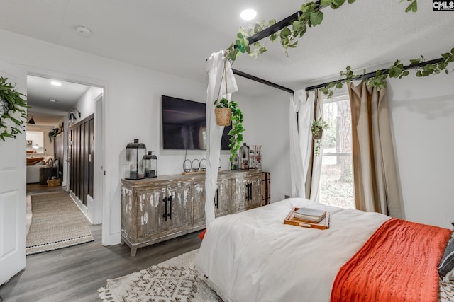 bedroom featuring a textured ceiling and wood finished floors