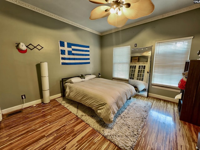 541 Georgia St, Columbia, SC 29201 - bedroom with visible vents, baseboards, ornamental molding, wood finished floors, and a ceiling fan