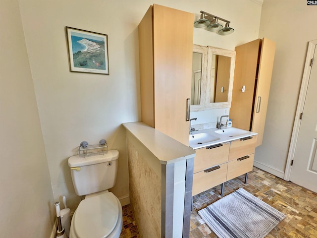 541 Georgia St, Columbia, SC 29201 - bathroom with vanity, brick floor, toilet, and baseboards
