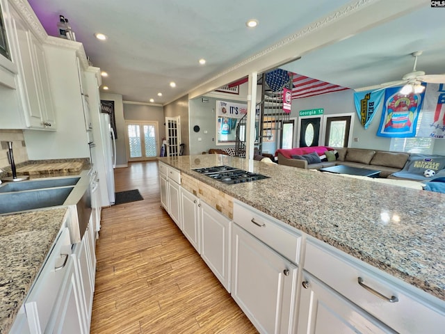 541 Georgia St, Columbia, SC 29201 - kitchen with stainless steel gas cooktop, ceiling fan, light wood-style floors, white cabinetry, and open floor plan