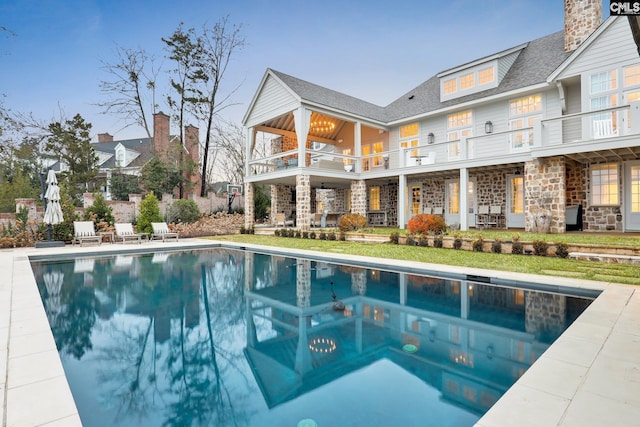 536 Yachting Rd, Lexington, SC 29072 - exterior space featuring stone siding, a shingled roof, an outdoor pool, a balcony, and a patio area