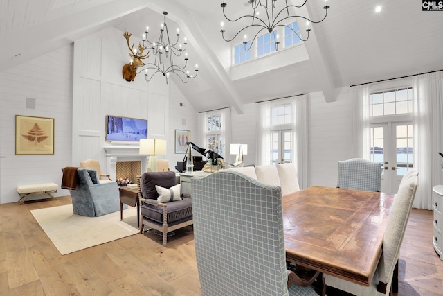 536 Yachting Rd, Lexington, SC 29072 - dining space featuring light wood-type flooring, high vaulted ceiling, plenty of natural light, french doors, and an inviting chandelier